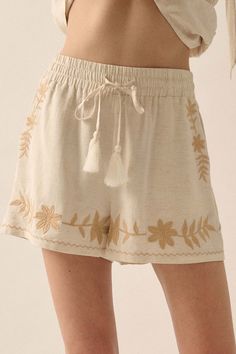 Rustic Blooms Floral Embroidered Linen-Blend Shorts - ShopPromesa Summer Cream Bottoms With Floral Embroidery, Cream Floral Embroidery Bottoms For Summer, Summer Floral Embroidery Cream Bottoms, Bohemian Short Length Bottoms With Drawstring, Casual Spring Shorts With Tassels, Casual Tassel Shorts For Spring, Casual Vacation Bottoms With Floral Embroidery, Casual Summer Bottoms With Embroidered Hem, Casual Embroidered Hem Bottoms For Summer