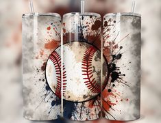 two baseball tumblers with paint splatters and a ball on the inside one