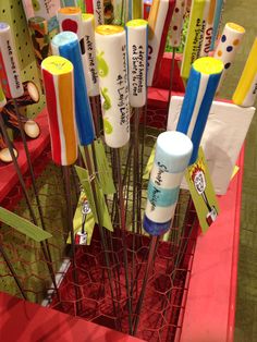 there are many different colored toothbrushes in the holder on this display case,