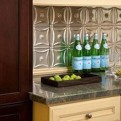 bottles and glasses on a counter in a kitchen