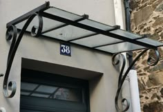 the number eighty sign is attached to the side of a building