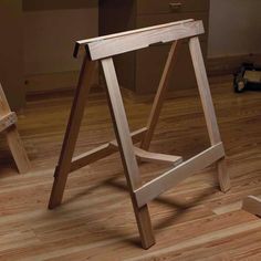 a wooden stool sitting on top of a hard wood floor next to a desk and chair