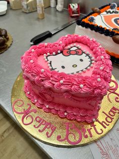 a hello kitty birthday cake on a table