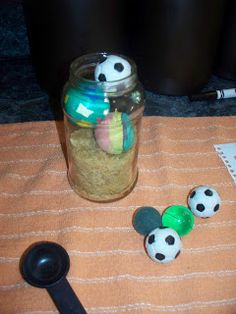 a jar filled with balls sitting on top of a table