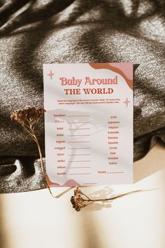 a baby around the world game sitting on top of a bed next to a sheet