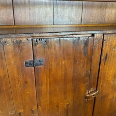 an old wooden cabinet with metal handles