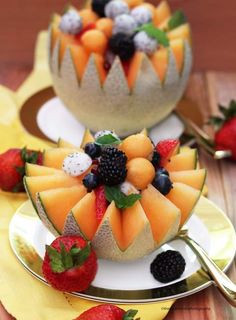 two bowls filled with fruit on top of plates