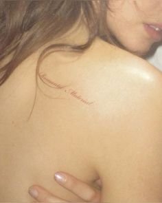 a woman with a tattoo on her shoulder