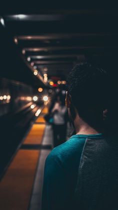 the man is waiting for the train at the station