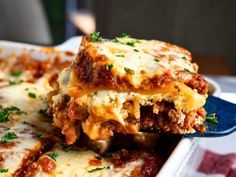 a blue and white plate topped with lasagna casserole