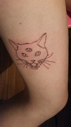 a cat's face is shown on the side of a woman's leg