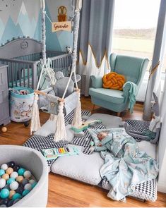 a baby's room is decorated in blue and gray colors with lots of toys on the floor