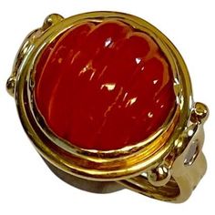 Carved carnelian is featured in this archaic style ring. The carnelian (origin: Brazil) is a brilliant "jelly candy orange" color and is expertly carved. The gem is flacked by a pair of bezel set white diamonds. The 18k gold, hand fabricated ring is in an archaic style. Similar rings may be seen in the Viking jewelry collection on display at the Danish National Museum. The ring is a size 7 and may be sized. Candy Orange, Jelly Candy, Aquamarine Colour, Contemporary Ring, Gold Hand, Modern Ring, Viking Jewelry, Blue Chalcedony, Three Stone Rings