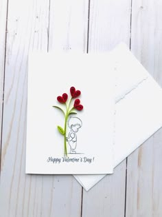 two valentine's day cards, one with a flower and the other with a card saying happy valentine's day