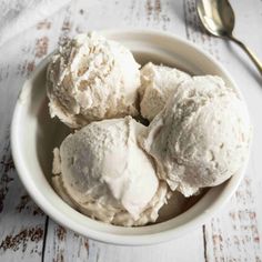 three scoops of ice cream in a white bowl