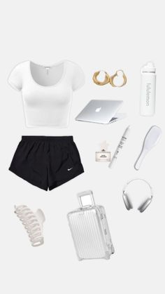 the contents of a woman's white top and black shorts are arranged on a white surface