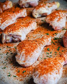 several pieces of meat covered in seasoning on a plate