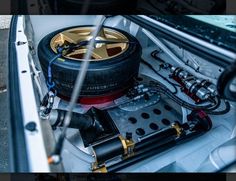 the engine compartment of a car with an electronic device in it's back end