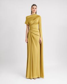 Evoke timeless grace with Gemy Maalouf's long evening dress, featuring an asymmetrical neckline, floor-length sleeve, and a draped waist. Crafted from luxurious satin in tender green, this piece welcomes slight modifications for a personalized touch.