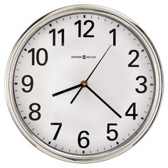 a white clock with black numbers on the face is shown in front of a white background