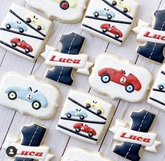 decorated cookies with cars and trucks on them are arranged in rows against a white background