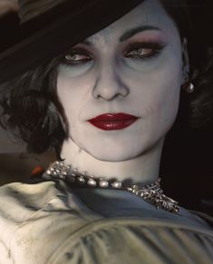 a close up of a woman wearing a hat and pearls on her neck with red lipstick