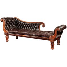 an antique wooden bench with leather upholstered seat