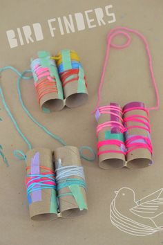 three rolls of colored paper tied together with twine