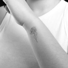 a person with a flower tattoo on their arm