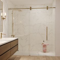 a bathroom with marble walls and wooden flooring, along with a walk in shower