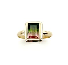 Beautiful and natural Watermelon Tourmaline set in 14k gold, this ring is a simple classic that lets the stone take center stage. Perfect gift for gem lovers, especially tourmaline collectors as this is an especially nice and balanced mix of pink and green tourmaline in one crystal. This  tourmaline measures 9mm by 7mm. The 14k bezel is 3mm tall and has a slim border around the setting. The band is 2mm wide and half round in shape. This ring is a size 7.5. The Watermelon Tourmaline is a rare var Watermelon Tourmaline, 14k Gold Ring, Green Gemstones, Green Tourmaline, Center Stage, Beautiful Gift Boxes, Bling Bling, Statement Ring, Rings Statement