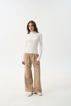 A timeless classic that suits everyone—this ribbed turtleneck with a mock neck is a versatile wardrobe staple. The soft ribbed knit provides warmth and comfort even in cold weather, while beautifully accentuating the silhouette. The mock neck and extended sleeves add a cozy and stylish touch to any outfit. For busy days, pair it with jeans or tailored pieces in neutral shades like black, white, beige, or gray. For special occasions, try combining this turtleneck with a satin skirt—we guarantee you'll look stunning. Short Tank Top, Neutral Shades, Versatile Wardrobe, Knit Turtleneck, Knit Turtleneck Sweater, Ribbed Turtleneck, Jean Top, Satin Skirt, White Beige