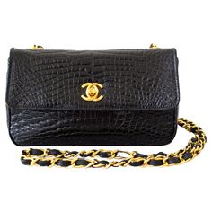 Introducing vintage Chanel classic mini flap from 1989. Crafted from luxurious black alligator leather and adorned with exquisite 24K Métal Doré Plaqué hardware ( Classic Gold Heavy Plated- Purest ), this piece exudes sophistication. A true collector's item, this bag is a rare find as Chanel no longer produces exotic skins and gold-plated hardware. As an investment piece, its value is only expected to grow over time Its sleek design features a gold interlocking CC twist lock, elongated leather a Luxury Black Bags With Gold Chain, Chanel Classic Flap Bag Vintage, Rare Chanel Bag, Chanel Rare Bag, Chanel Suit, Black And Gold Chanel Bag, Black Alligator, Vintage Chanel Bag, Chanel Brand