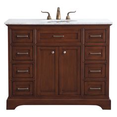 a bathroom vanity with marble top and two faucets