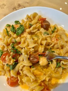 a white plate topped with pasta and vegetables