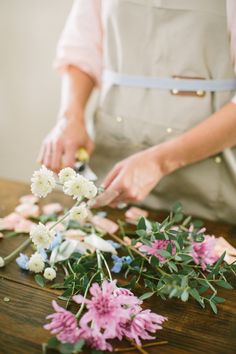 a person cutting up flowers on a table