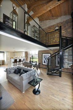 a living room filled with furniture and a spiral staircase