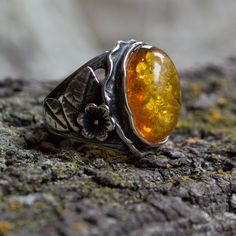 In the garden This is a gorgeous amber ring made from sterling silver with floral elements from each side of the cocktail ring. (R1771-1). © 2011-2015, Artisanimpact Inc. All rights reserved. Construction & Dimensions: Sterling silver, amber. Approximate length on top: 22mm (0.86in). We can make any size, including quarter sizes. Please choose your size in the drop down menu, when you check out. About our jewelry Artisanimpact features a variety of brass, silver and 14k gold jewelry. Ancient Botanical Ring, Amber Gemstone, Nature Ring, Gold And Silver Rings, Amber Ring, Crown Jewels, 14k Gold Ring, Ring Engagement, Ring Sterling Silver