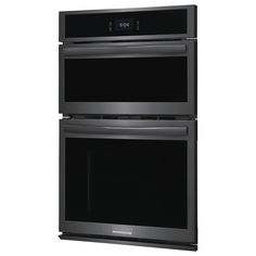 two black double ovens side by side against a white background with the door open