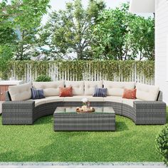 an outdoor sectional couch with pillows on the grass