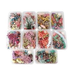 many different types of beads in plastic containers