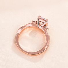 an engagement ring is shown on a white surface