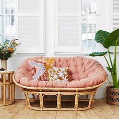 a living room filled with furniture and plants