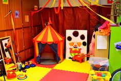 there is a circus tent and other toys on the floor in this playroom area