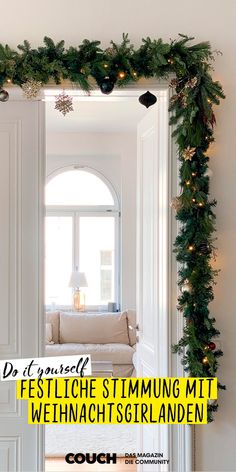 a living room decorated for christmas with lights and greenery on the wall, in front of a mirror