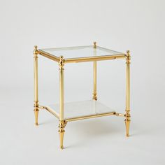 The Medford Tables feature a two-tiered design with luxurious white marble and tempered glass in a polished brass frame  perfect for both entertainment and storage. Dimensions Overall 20"L x 20"W x 22.75"H (56 lbs)  Finish Shiny Brass Shiny Brass Clean glass with professional glass cleaner; Dust with a soft, dry cloth Glass is clear tempered 8 mm thick Table Glass Design, Small Nightstand Ideas, Gold Nightstand, Glass Bedside Table, Glass Side Table, Small Nightstand, Brass Side Table, Glass Side Tables, Global Views