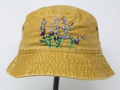 Item: flower embroidered bucket hat Material: 100% cotton Size: one size fits most Embroidery: hand made with acrylic thread Free first class shipping, upgradable priority mail service. 30 days return policy, feel confident at your purchase! Casual Cotton Sun Hat With Embroidery, Yellow Cotton Bucket Hat With Short Brim, Casual Embroidered Cotton Bucket Hat, Yellow Cotton Bucket Hat With Curved Brim, Yellow Cotton Bucket Hat For Spring, Spring Yellow Cotton Bucket Hat, Handmade Yellow Cotton Hats, Casual Purple Cotton Bucket Hat, Summer Cotton Bucket Hat With Embroidered Logo