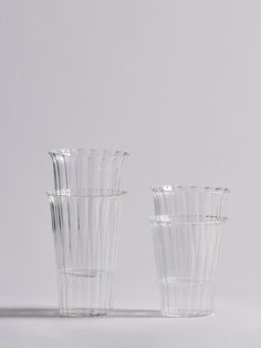 three clear glass vases sitting next to each other