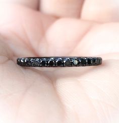 a black diamond ring in someone's hand