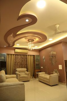 a living room with two couches and a chandelier hanging from the ceiling